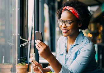  A woman talking on the phone and holding and looking at a credit card