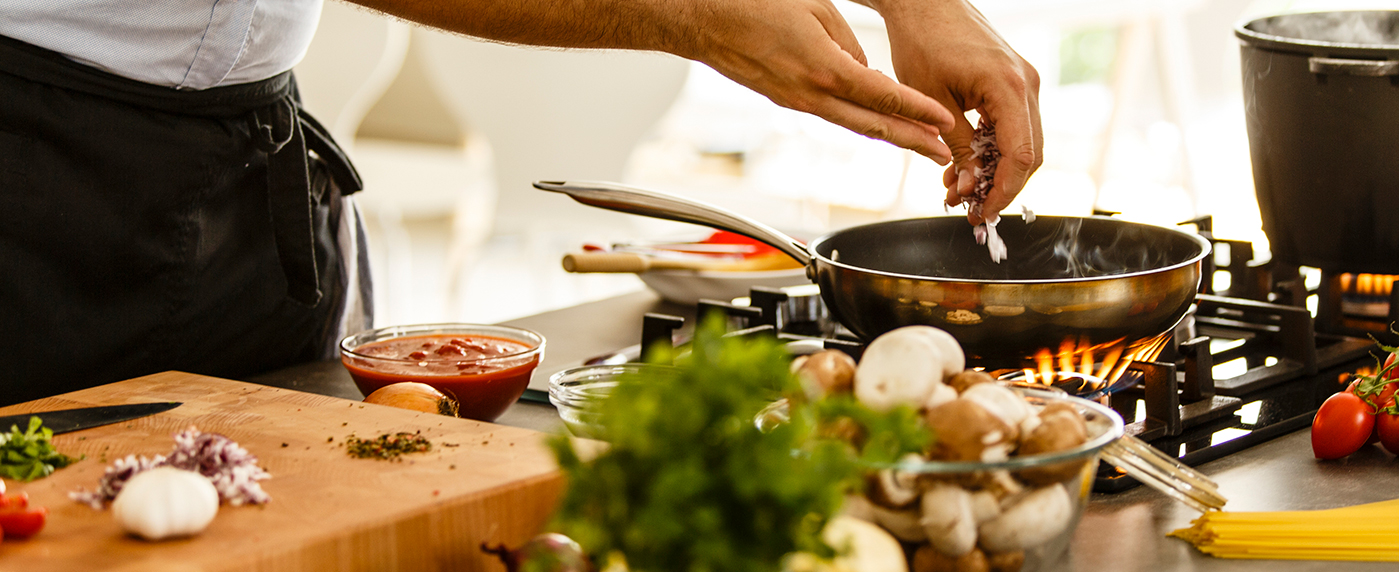 A person cooking on a gas stove