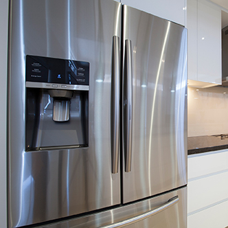 A side-by-side stainless steel refrigerator and freezer