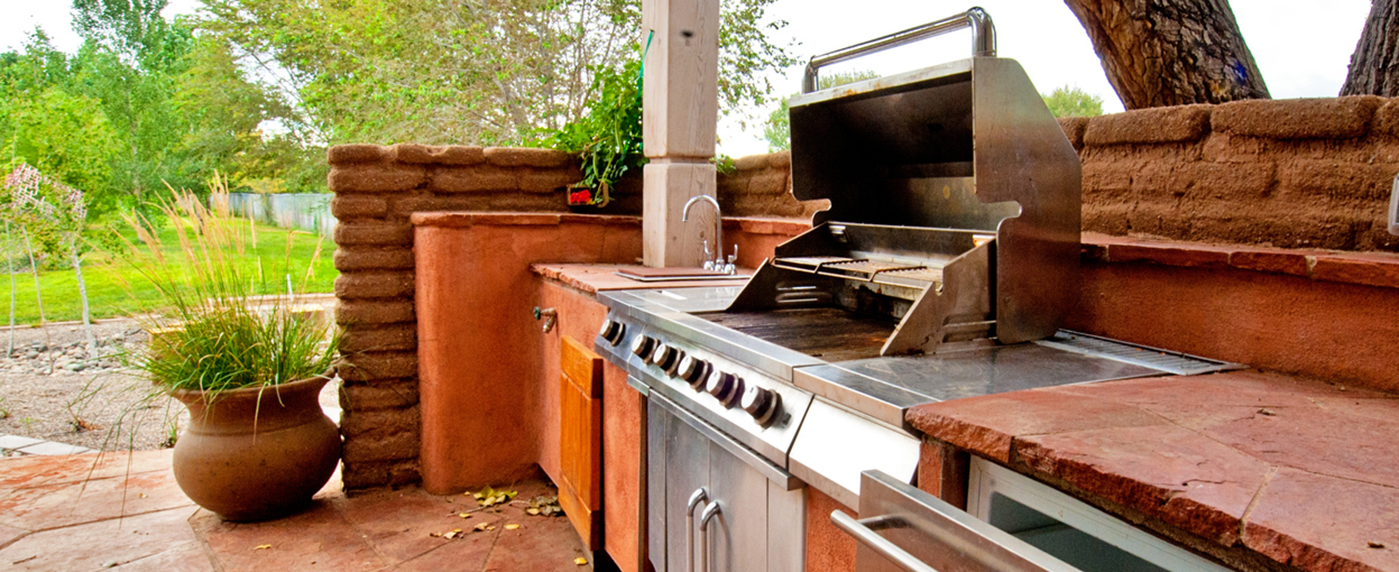 A gas grill on an outdoor deck