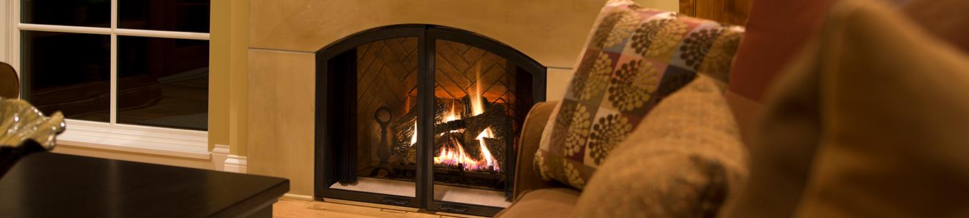A gas fireplace with a fire burning