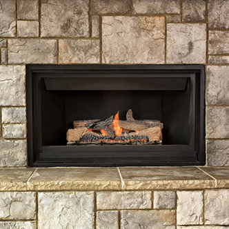 A gas-powered fireplace with a fire blazing