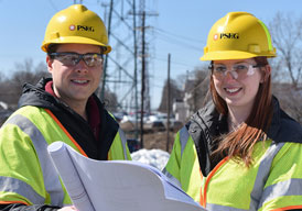 Two, PSE&G cosntruction workers are shown.